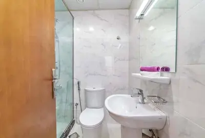 a bathroom with a toilet and a sink and a shower at Sea View Apartments Marina with Party Hall in Dubai