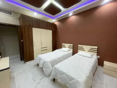 a bedroom with two beds and a purple light at Sea View Apartments Marina with Party Hall in Dubai