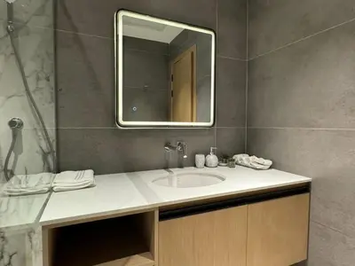 a bathroom with a sink and a mirror at Sea View Apartments Marina with Party Hall in Dubai