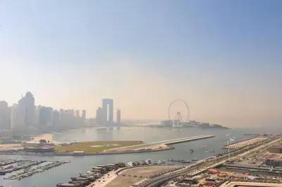 an aerial view of a city with a river and a city at Vogue Emaar Beachfront Beach Vista near JBR and Palm Jumeirah, One Bedroom Apartment with Balcony and Private Beach, Access to all Amenities in Dubai