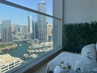 a room with a large window with a view of a harbor at Beautiful Studio Apartment in Dubai Marina in Dubai