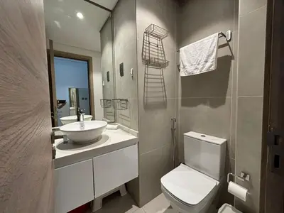 a bathroom with a white toilet and a sink at Beautiful Studio Apartment in Dubai Marina in Dubai