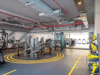 a gym with treadmills and machines in a room at Beautiful Studio Apartment in Dubai Marina in Dubai