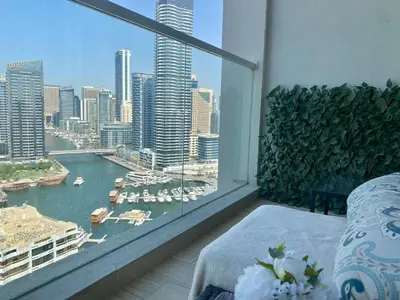 a balcony with a view of a harbor and buildings at Beautiful Studio Apartment in Dubai Marina in Dubai