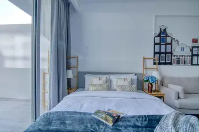 a bedroom with a bed and a chair at The Smart Concierge - Luma 21 in Dubai