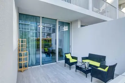 a balcony with two chairs and a table at The Smart Concierge - Luma 21 in Dubai