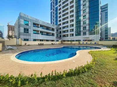 a large building with a swimming pool in front of it at StoneTree - Marina Diamond Studio - Near Metro Station in Dubai