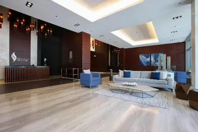 a lobby with a couch and a table in a building at Vogue Marina Gate near JBR Beach and Marina Mall, One Bedroom Apartment with Balcony and city skyline view, Access to all Amenities in Dubai