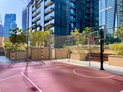 a basketball court in the middle of a city at Vogue Marina Gate near JBR Beach and Marina Mall, One Bedroom Apartment with Balcony and city skyline view, Access to all Amenities in Dubai