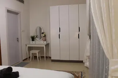 a bedroom with a bed and a table with a mirror at Newly furnished cozy 1 bedroom apartment close to JBR beach and metro in Dubai