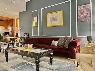 a living room with a red couch and a coffee table at Chic 3 bedroom apartment in Dubai