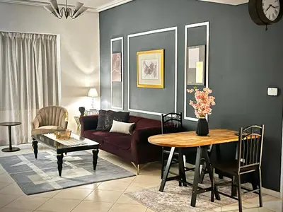 a living room with a couch and a table at Chic 3 bedroom apartment in Dubai