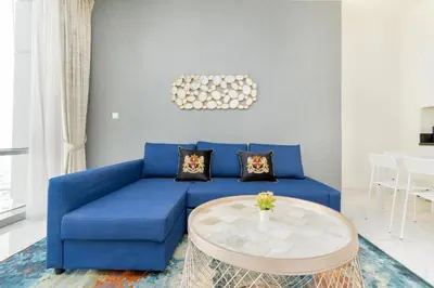 a blue couch in a living room with a table at Lux BnB I Amna Tower I Panaromic Views in Dubai