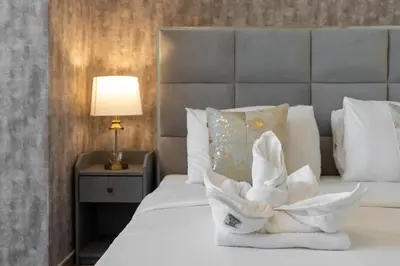 a hotel room with a bed with a white towel at Lux BnB I Amna Tower I Panaromic Views in Dubai