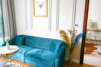 a blue couch in a living room with a table at Vera Residence with Canal View in Dubai
