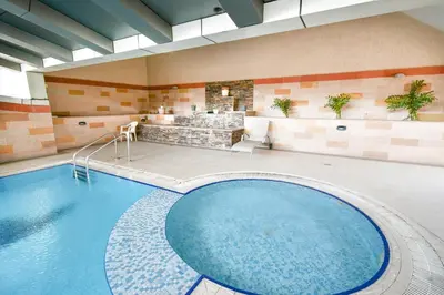 a large swimming pool in a hotel room at Scala Tower Central Chic with a twist studio in Dubai