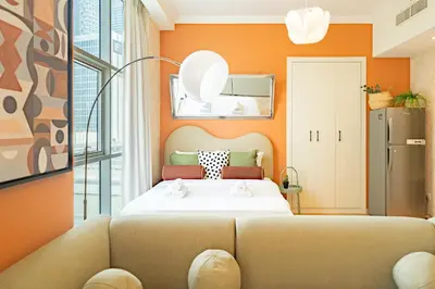 a bedroom with a bed and a couch at Scala Tower Central Chic with a twist studio in Dubai