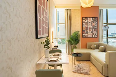 a living room with a couch and a table at Scala Tower Central Chic with a twist studio in Dubai