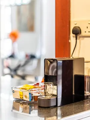 a microwave sitting on a counter with a glass at Spacious 2BR - Dubai Eye & Sea View - JBR in Dubai