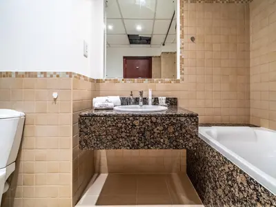 a bathroom with a sink and a tub and a toilet at Spacious 2BR - Dubai Eye & Sea View - JBR in Dubai