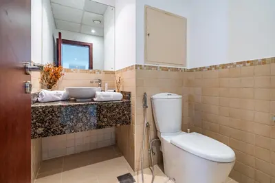 a bathroom with a toilet and a sink at Spacious 2BR - Dubai Eye & Sea View - JBR in Dubai