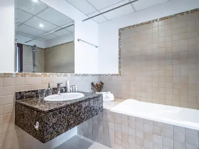 a bathroom with a large sink and a tub at Spacious 2BR - Dubai Eye & Sea View - JBR in Dubai