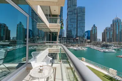 a balcony with a table and a view of a harbor at Vacay Lettings- Stylish waterfront getaway home in Dubai