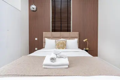 a bedroom with a large bed with towels on it at Vacay Lettings- Stylish waterfront getaway home in Dubai