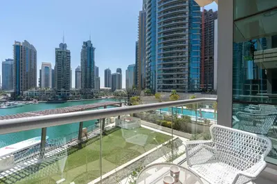a balcony with chairs and a view of the city at Vacay Lettings- Stylish waterfront getaway home in Dubai