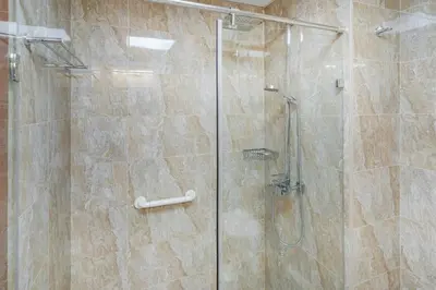 a bathroom with a shower with a glass door at 1bd apt plus study I Close to mall I Fast wi-fi in Dubai