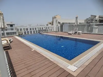 a swimming pool on the roof of a building at 1bd apt plus study I Close to mall I Fast wi-fi in Dubai