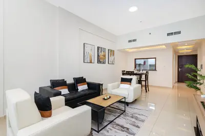 a living room with a couch and a table at 1bd apt plus study I Close to mall I Fast wi-fi in Dubai