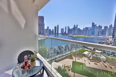 a balcony with a table and a view of the city at Winds of the Canal by Lagom - Business Bay Dubai in Dubai