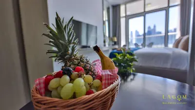 a basket of fruit sitting on a table at Winds of the Canal by Lagom - Business Bay Dubai in Dubai