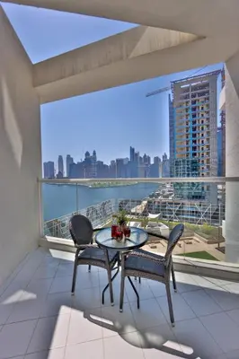 a balcony with a table and chairs and a view of the city at Winds of the Canal by Lagom - Business Bay Dubai in Dubai