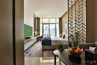a hotel room with a king bed and a desk at Winds of the Canal by Lagom - Business Bay Dubai in Dubai