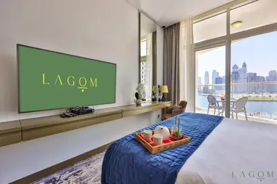 a hotel room with a bed and a flat screen tv at Winds of the Canal by Lagom - Business Bay Dubai in Dubai