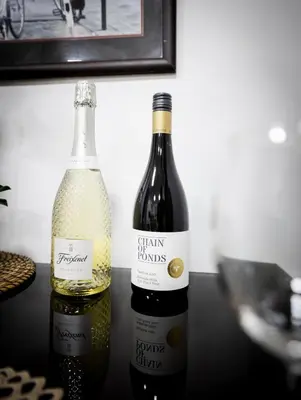 two bottles of wine sitting on a table at 2 Bedroom App with private beach and infinity pool in Dubai