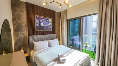 a hotel room with a bed and a window at STAY La Casa Da Vinci 1BR Holiday Home CVR B3002 near Burj Khalifa in Dubai