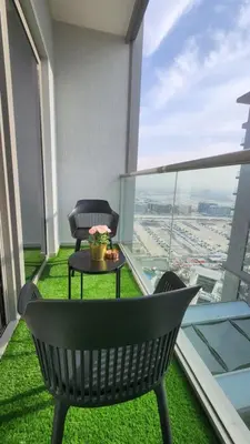 a balcony with a table and two chairs on a building at STAY La Casa Da Vinci 1BR Holiday Home CVR B3002 near Burj Khalifa in Dubai