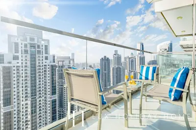 a balcony with chairs and a view of the city at LUX Paramount Burj View Business Bay in Dubai