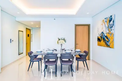 a dining room with a table and chairs at LUX Paramount Burj View Business Bay in Dubai