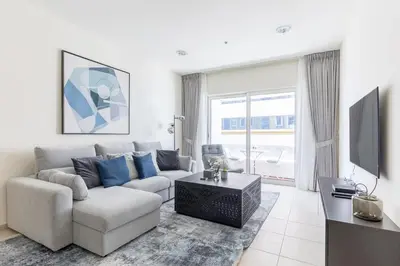 a living room with a couch and a tv at High Floor Elegance,Prime Location-Close to tram in Dubai