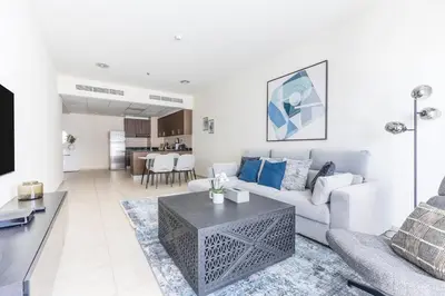 a living room with a couch and a table at High Floor Elegance,Prime Location-Close to tram in Dubai