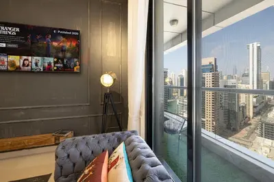 a living room with a couch and a large window at Beautiful home, Magnificent view in Dubai