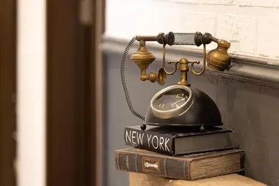 a old telephone sitting on top of a book at Beautiful home, Magnificent view in Dubai