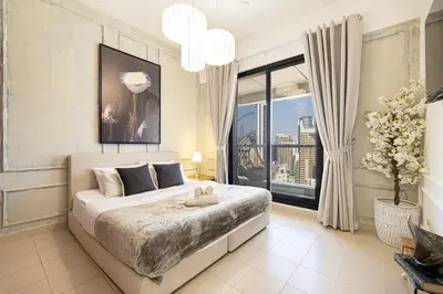 a bedroom with a large bed and a large window at Beautiful home, Magnificent view in Dubai