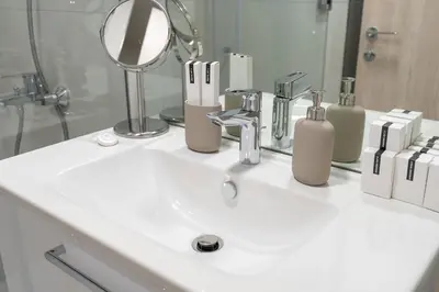 a bathroom sink with a mirror and a white sink at Very Cozy & Relaxing Studio in JVC in Dubai