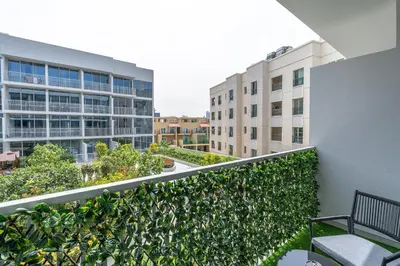 a balcony with a bench and some buildings at Very Cozy & Relaxing Studio in JVC in Dubai
