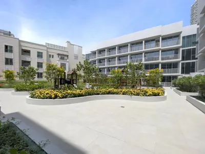 an empty courtyard in front of a building at Bright & Modern Studio in JVC in Dubai
